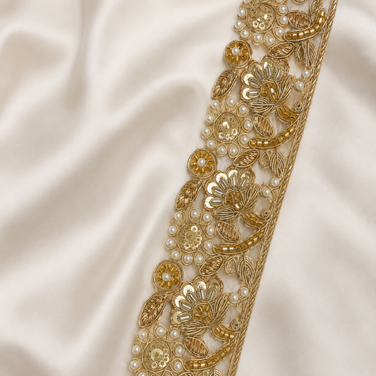 Gold embroidered fabric with pearls on a satin background