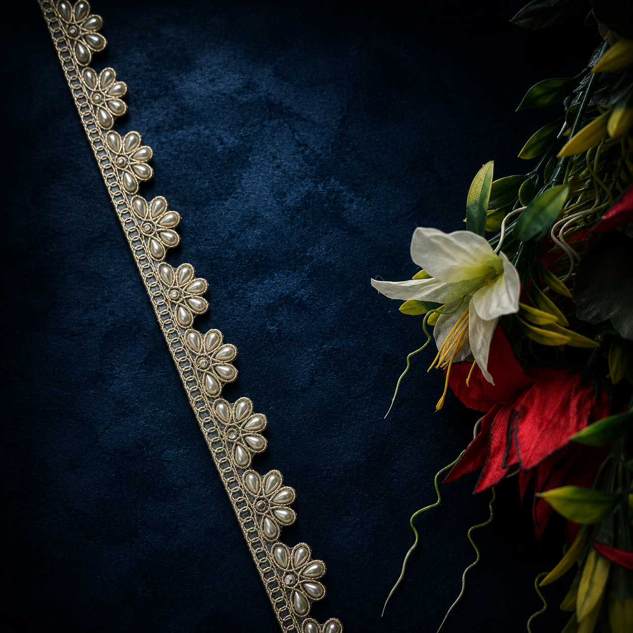 Decorative floral belt on a dark blue textured background with flowers.